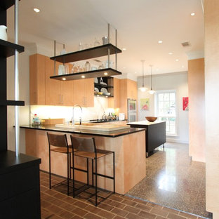 Inspiration for a mid-sized eclectic u-shaped kitchen in Houston with flat-panel cabinets, light wood cabinets, marble benchtops, grey splashback, stone slab splashback, stainless steel appliances, ceramic floors, a peninsula, an integrated sink and grey floor.