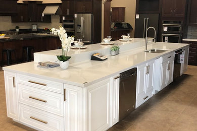 Inspiration for a large modern kitchen/diner in Sacramento with a submerged sink, engineered stone countertops, white splashback, stone slab splashback, stainless steel appliances, porcelain flooring, an island, beige floors and white worktops.