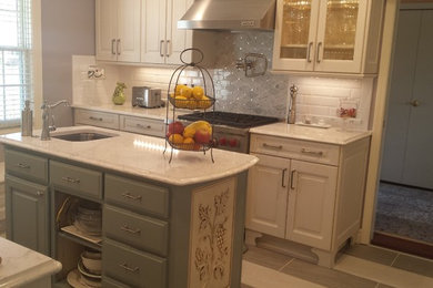 Inspiration for a small transitional u-shaped ceramic tile eat-in kitchen remodel in Other with an undermount sink, raised-panel cabinets, white cabinets, marble countertops, white backsplash, subway tile backsplash, stainless steel appliances and an island