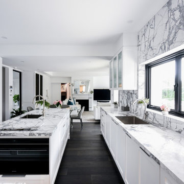 Kitchen with white shaker profile cabinets and marble benchtops