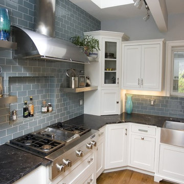 Finished cooking area with vent and beautiful tile backsplash