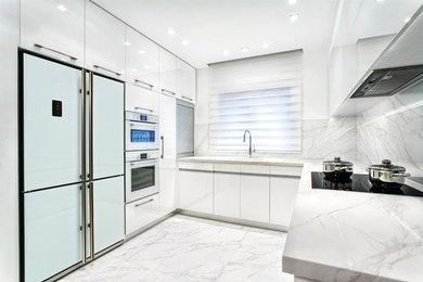 Example of a mid-sized minimalist u-shaped marble floor enclosed kitchen design in Miami with an undermount sink, flat-panel cabinets, white cabinets, marble countertops, marble backsplash and stainless steel appliances