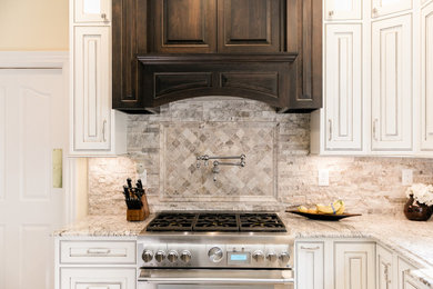 Inspiration for a large timeless l-shaped terra-cotta tile and beige floor enclosed kitchen remodel in Other with a farmhouse sink, beaded inset cabinets, white cabinets, granite countertops, gray backsplash, stone tile backsplash, stainless steel appliances, an island and brown countertops