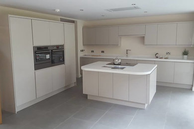 This is an example of a medium sized contemporary kitchen in Other with quartz worktops and an island.