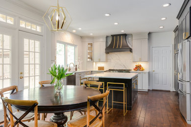 Example of a minimalist l-shaped dark wood floor and wood ceiling eat-in kitchen design in DC Metro with a drop-in sink, flat-panel cabinets, white cabinets, quartzite countertops, white backsplash, quartz backsplash, stainless steel appliances, an island and white countertops