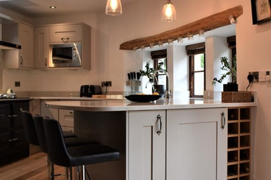 Photo of a small classic u-shaped kitchen/diner in Other with shaker cabinets, grey cabinets, quartz worktops and beige worktops.