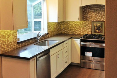 Small shabby-chic style u-shaped kitchen/diner in Sacramento with a submerged sink, shaker cabinets, stainless steel cabinets, engineered stone countertops, multi-coloured splashback, mosaic tiled splashback, stainless steel appliances, medium hardwood flooring and no island.