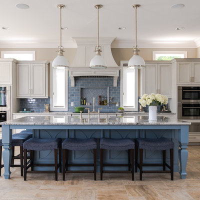 Inspiration for a coastal l-shaped beige floor kitchen remodel in Other with blue cabinets, blue backsplash, subway tile backsplash, an island and recessed-panel cabinets