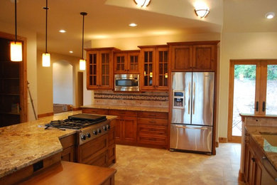Mid-sized minimalist u-shaped enclosed kitchen photo in Albuquerque with an undermount sink, recessed-panel cabinets, dark wood cabinets, granite countertops, beige backsplash, stainless steel appliances and an island