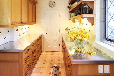 Example of a mid-sized classic galley ceramic tile and pink floor kitchen design in New York with medium tone wood cabinets, stainless steel countertops, white backsplash and porcelain backsplash