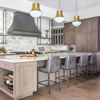 Inspiration for a huge transitional medium tone wood floor kitchen remodel in Houston with a farmhouse sink, recessed-panel cabinets, quartzite countertops, multicolored backsplash, stainless steel appliances, an island, multicolored countertops, medium tone wood cabinets and stone slab backsplash