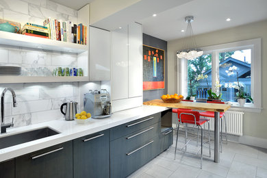 Trendy eat-in kitchen photo in Toronto with an undermount sink, flat-panel cabinets and white backsplash