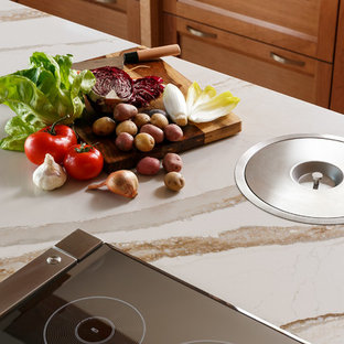 Inspiration for an expansive transitional l-shaped separate kitchen in Louisville with an undermount sink, recessed-panel cabinets, medium wood cabinets, quartz benchtops, white splashback, stone slab splashback, stainless steel appliances, porcelain floors, multiple islands, multi-coloured floor and white benchtop.