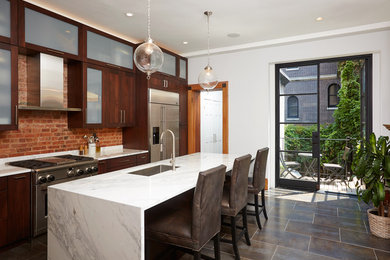 Example of a large transitional single-wall ceramic tile enclosed kitchen design in New York with a single-bowl sink, dark wood cabinets, marble countertops, brown backsplash, stainless steel appliances and an island