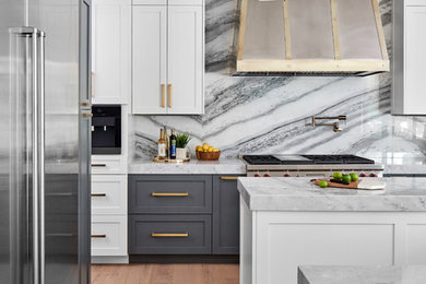Inspiration for a mid-sized transitional l-shaped light wood floor and gray floor open concept kitchen remodel in Austin with a farmhouse sink, shaker cabinets, gray cabinets, quartzite countertops, multicolored backsplash, marble backsplash, stainless steel appliances, two islands and blue countertops