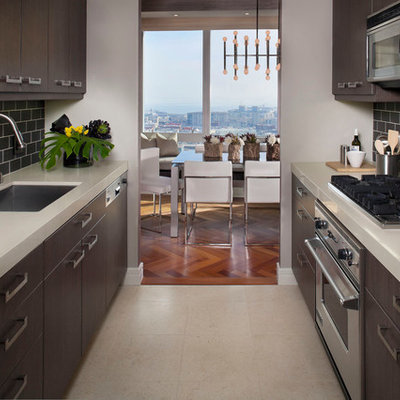 Enclosed kitchen - contemporary galley enclosed kitchen idea in San Francisco with subway tile backsplash, stainless steel appliances, an undermount sink, flat-panel cabinets and dark wood cabinets