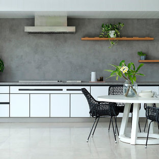 Design ideas for a mid-sized contemporary single-wall kitchen in Perth with flat-panel cabinets, white cabinets, grey splashback, panelled appliances, no island, grey floor and grey benchtop.