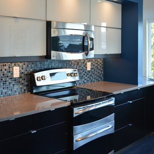 Photo of a mid-sized contemporary l-shaped open plan kitchen in Seattle with an undermount sink, glass-front cabinets, white cabinets, quartz benchtops, blue splashback, glass tile splashback, stainless steel appliances, linoleum floors and with island.