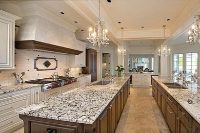 Example of a large transitional single-wall travertine floor eat-in kitchen design in Vancouver with an undermount sink, raised-panel cabinets, dark wood cabinets, granite countertops, white backsplash, subway tile backsplash, paneled appliances and two islands