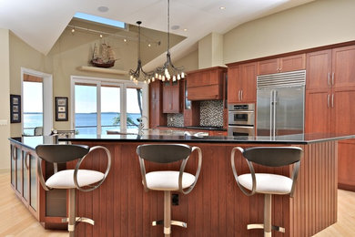 Design ideas for a large classic u-shaped open plan kitchen in Tampa with a submerged sink, shaker cabinets, medium wood cabinets, engineered stone countertops, multi-coloured splashback, mosaic tiled splashback, stainless steel appliances, light hardwood flooring, multiple islands and brown floors.