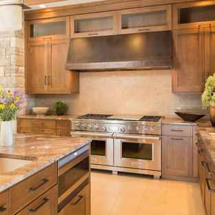 Inspiration for a large arts and crafts u-shaped eat-in kitchen in St Louis with an undermount sink, recessed-panel cabinets, medium wood cabinets, quartz benchtops, brown splashback, porcelain splashback, panelled appliances, porcelain floors and with island.