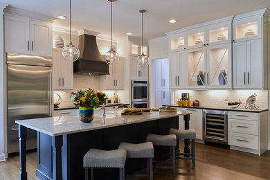 Eat-in kitchen - contemporary l-shaped brown floor and light wood floor eat-in kitchen idea in Other with marble countertops, white backsplash, white countertops, stainless steel appliances, an island, white cabinets and recessed-panel cabinets