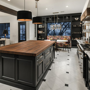 Expansive shabby-chic style u-shaped eat-in kitchen in Phoenix with an undermount sink, recessed-panel cabinets, black cabinets, wood benchtops, multi-coloured splashback, porcelain splashback, panelled appliances, porcelain floors, with island, multi-coloured floor and multi-coloured benchtop.