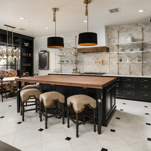 Immagine di un'ampia cucina stile shabby con lavello sottopiano, ante con riquadro incassato, ante nere, top in legno, paraspruzzi multicolore, paraspruzzi in gres porcellanato, elettrodomestici da incasso, pavimento in gres porcellanato, pavimento multicolore e top multicolore