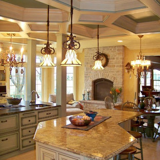 Photo of an expansive eclectic eat-in kitchen in Chicago with raised-panel cabinets, yellow cabinets, granite benchtops, porcelain splashback, coloured appliances, travertine floors and multiple islands.