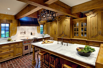 French country kitchen photo in Other with raised-panel cabinets, stainless steel appliances and marble countertops