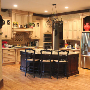 Large traditional separate kitchen in Other with raised-panel cabinets, beige cabinets, ceramic splashback, stainless steel appliances, medium hardwood floors and with island.