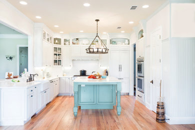 Inspiration for a country light wood floor kitchen remodel in Austin with a farmhouse sink, beaded inset cabinets and white cabinets