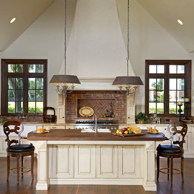 Inspiration for a timeless u-shaped kitchen remodel in Orlando with raised-panel cabinets, beige cabinets and paneled appliances
