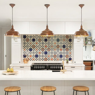 Inspiration for a transitional kitchen in Perth with shaker cabinets, white cabinets, multi-coloured splashback, black appliances, with island and white benchtop.