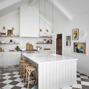 This is an example of a large transitional u-shaped eat-in kitchen in Chicago with a farmhouse sink, shaker cabinets, grey cabinets, white splashback, terra-cotta splashback, stainless steel appliances, marble floors, with island, multi-coloured floor and white benchtop.