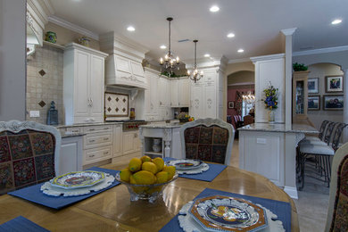 Inspiration for a large timeless u-shaped open concept kitchen remodel in Tampa with raised-panel cabinets, white cabinets, granite countertops, stone tile backsplash, paneled appliances and an island