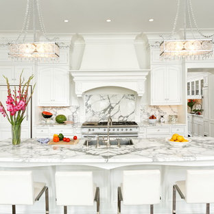 Traditional kitchen pictures - Elegant galley kitchen photo in DC Metro with marble countertops, a single-bowl sink, beaded inset cabinets, white cabinets, white backsplash, stone slab backsplash and paneled appliances