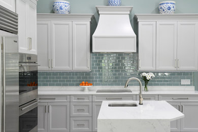 Eat-in kitchen - mid-sized traditional l-shaped porcelain tile and gray floor eat-in kitchen idea in Atlanta with an undermount sink, gray cabinets, solid surface countertops, blue backsplash, glass tile backsplash, stainless steel appliances, two islands and white countertops