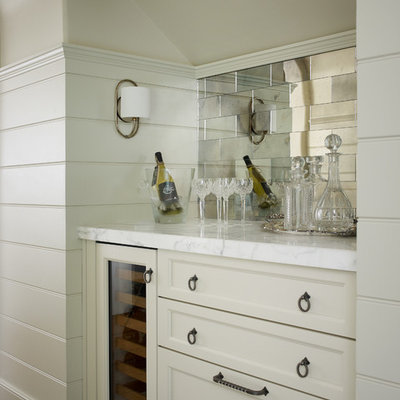 Enclosed kitchen - mid-sized transitional u-shaped medium tone wood floor and brown floor enclosed kitchen idea in Atlanta with marble countertops, a farmhouse sink, beaded inset cabinets, white cabinets, gray backsplash, subway tile backsplash, stainless steel appliances and an island