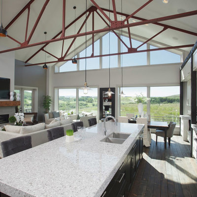 Inspiration for a large industrial galley medium tone wood floor and brown floor open concept kitchen remodel in Calgary with an undermount sink, shaker cabinets, white cabinets, multicolored backsplash, matchstick tile backsplash, stainless steel appliances and an island