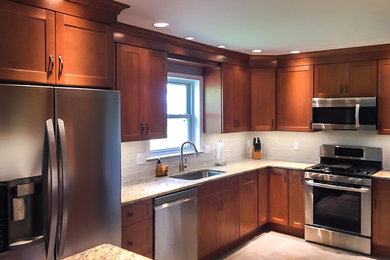 Small transitional u-shaped travertine floor and beige floor enclosed kitchen photo in Philadelphia with an undermount sink, shaker cabinets, medium tone wood cabinets, granite countertops, gray backsplash, subway tile backsplash, stainless steel appliances, no island and beige countertops