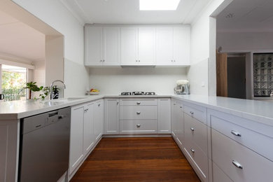 Idéer för små funkis vitt kök, med en undermonterad diskho, skåp i shakerstil, vita skåp, bänkskiva i kvarts, vitt stänkskydd, stänkskydd i sten och rostfria vitvaror