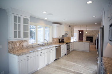 Example of a mid-sized transitional galley ceramic tile open concept kitchen design in Cedar Rapids with an undermount sink, raised-panel cabinets, white cabinets, granite countertops, no island and stainless steel appliances