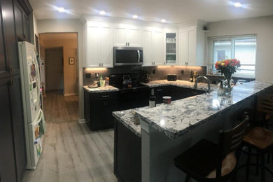 Small transitional u-shaped eat-in kitchen photo in Miami with an undermount sink, shaker cabinets, quartz countertops, glass tile backsplash and a peninsula
