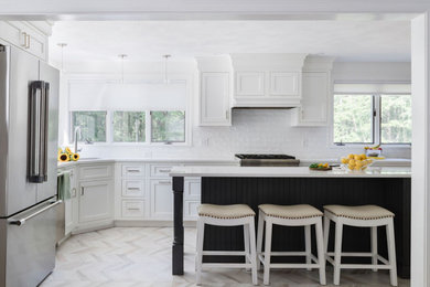 Example of a transitional gray floor and porcelain tile kitchen design in Boston with a single-bowl sink, white cabinets, white backsplash, subway tile backsplash, stainless steel appliances, an island, white countertops and quartz countertops