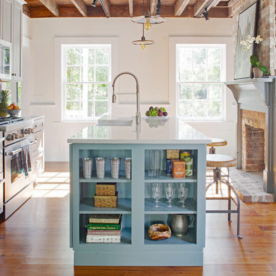 Example of a small farmhouse galley medium tone wood floor and brown floor enclosed kitchen design in Other with a farmhouse sink, gray cabinets, quartz countertops, blue backsplash, terra-cotta backsplash, stainless steel appliances, an island, white countertops and recessed-panel cabinets