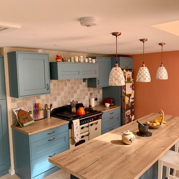 Fun family kitchen.  Blue Painted shaker kitchen with imitation wood worksurface