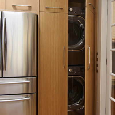 Enclosed kitchen - small modern l-shaped light wood floor and brown floor enclosed kitchen idea in Seattle with a single-bowl sink, flat-panel cabinets, light wood cabinets, quartz countertops, white backsplash, ceramic backsplash, stainless steel appliances and an island