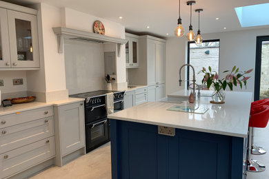 Photo of a classic kitchen in West Midlands with a belfast sink, quartz worktops and an island.