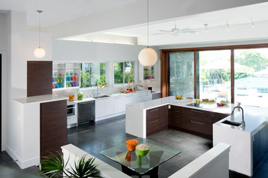 Eat-in kitchen - large contemporary u-shaped slate floor and gray floor eat-in kitchen idea in Hawaii with an undermount sink, flat-panel cabinets, white cabinets, quartz countertops, white backsplash, paneled appliances and an island